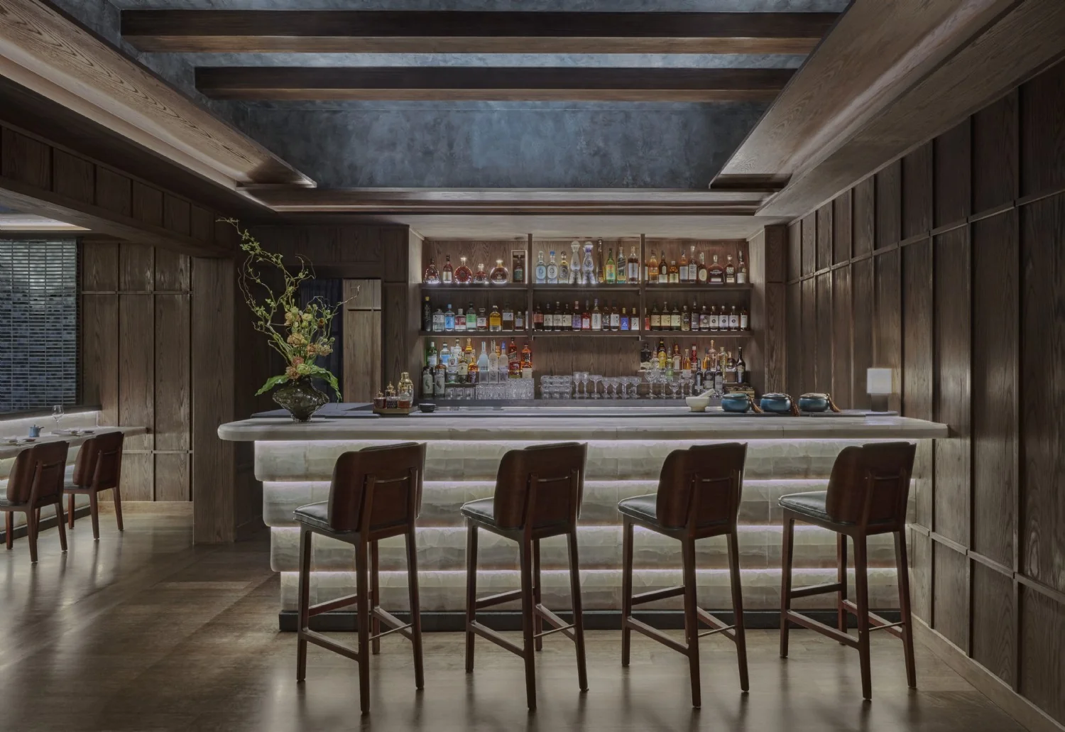MICRO 5 ALTA cove lighting under exposed beams above an onyx bar