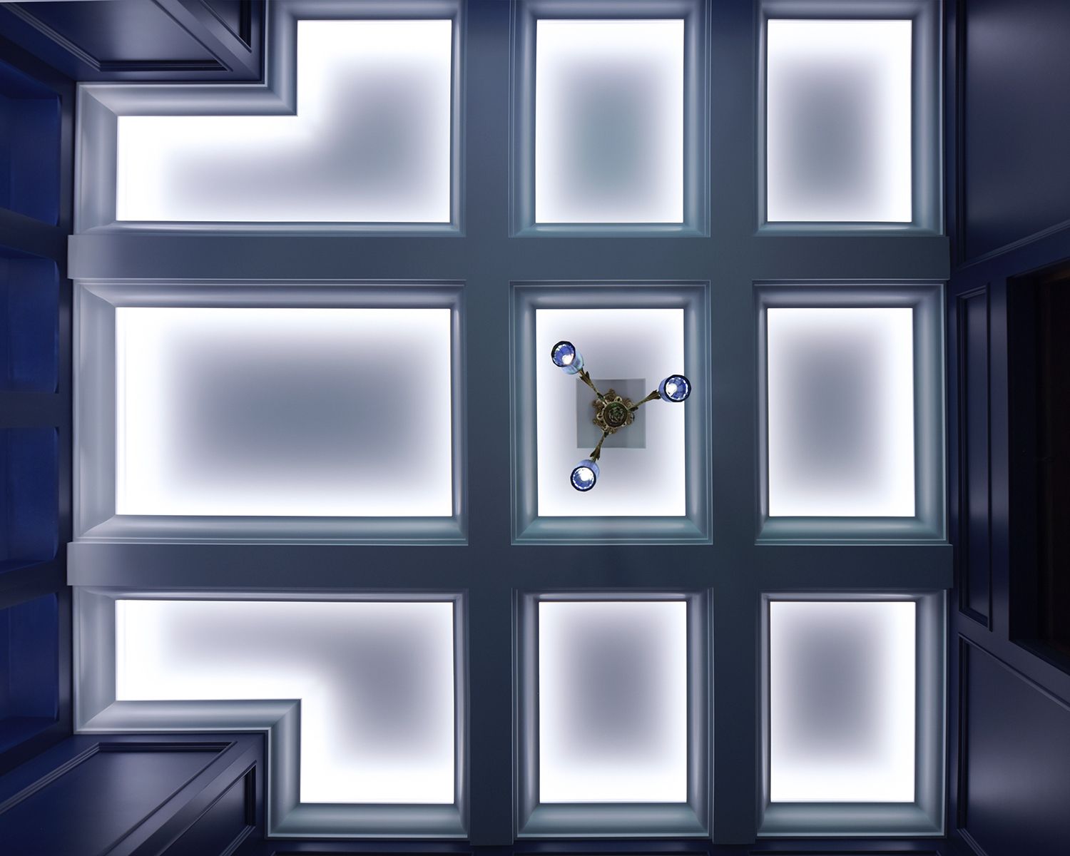 Clear diffused lines of cove lighting in a grand recessed ceiling