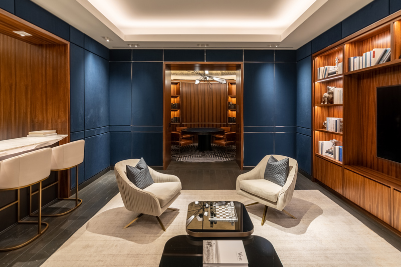 A rectangular and navy colored game room with a chess table leading into the dome-shaped poker room