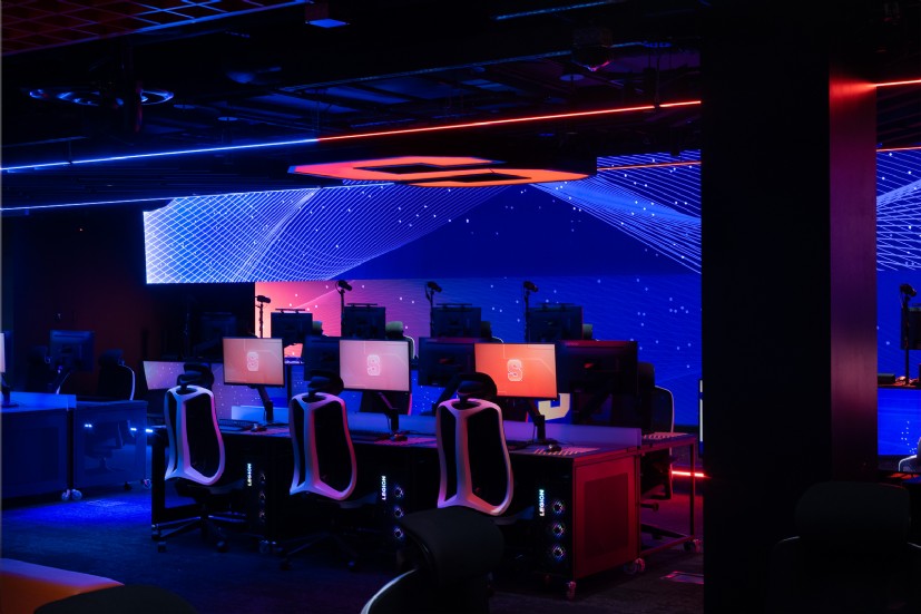 Esports lighting installation with linear LEDs illuminating Syracuse University gaming center by QTL.