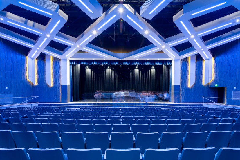 Union School auditorium lighting by QTL creates warm, balanced architectural illumination